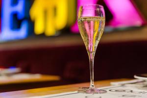 a glass of champagne sitting on a table at Hôtel Bristol Reims in Reims