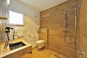 a bathroom with a shower and a toilet and a sink at Logis Hôtel La Chaize in Noirmoutier-en-l'lle
