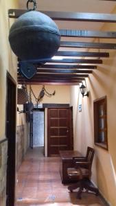 a room with a table and a pot hanging from a ceiling at Hotel Progreso in Progreso