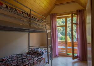 a bedroom with two bunk beds and a window at Sno House in Szczyrk