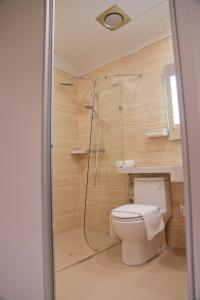 a bathroom with a shower and a toilet at Top Holiday Hotel in Seri Kembangan