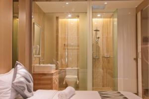 a bathroom with a shower and a toilet and a sink at Top Holiday Hotel in Seri Kembangan