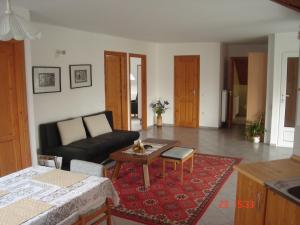 a living room with a couch and a table at Fortuna Apartman in Bük