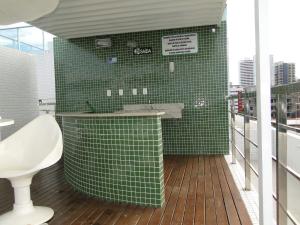 uma casa de banho com azulejos verdes, um lavatório e um WC. em Flat Jampa Cobertura Duplex A Beira Mar em João Pessoa mais 17 fotografias