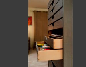 a room with a book shelf with boxes and books at Chambre d'hôtes Au Fil de l'Eau in Saint-Martin-Belle-Roche