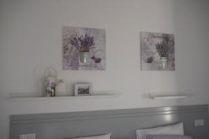 a white fireplace with two pictures on the wall at Oporto Living Apartments in Porto