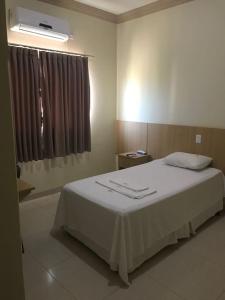 Ένα ή περισσότερα κρεβάτια σε δωμάτιο στο Hotel Rotamerica