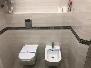 a bathroom with a toilet and a bidet at The Rooms Apart in Odesa