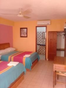 A bed or beds in a room at Hotel Progreso