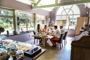 a group of people sitting around a table in a store at B&B 't Heirweggoed in Assenede