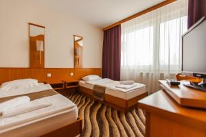 Voodi või voodid majutusasutuse Premium Hotel Panoráma toas