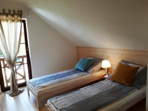 Postel nebo postele na pokoji v ubytování Kubiczówka