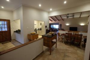 a living room and kitchen with a table and chairs at Thatch by the Sea in Blythedale
