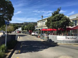 a street in a town with a sign that reads the united at The Studio Akaroa with car park in Akaroa