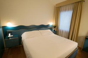 Postel nebo postele na pokoji v ubytování Hotel Antico Mulino