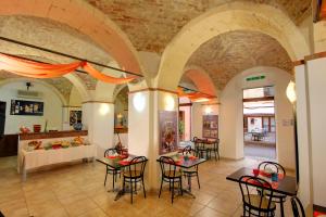 a lobby with tables and chairs in a building at Hostel Marina in Cagliari