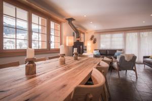 a large wooden table in a living room with a couch at Billabong in Grindelwald