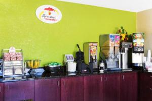 a kitchen with a counter top with food items on it at Super 8 by Wyndham Brunswick/St Simons Island Area in Brunswick