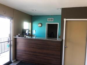 a bar in a room with a clock on the wall at Northgate Motel in El Cajon