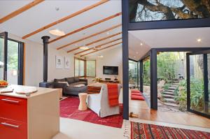 an open living room with a couch and a table at Bamboo Cottage in Johannesburg