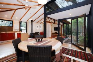 a kitchen and living room with a table and chairs at Bamboo Cottage in Johannesburg