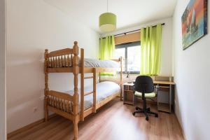 a bedroom with a bunk bed and a desk with a chair at Lovely 3 bedroom for the Perfect stay in Lisbon in Lisbon