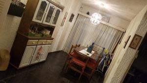 a kitchen with a table and chairs and a chandelier at Villaggio Riviera in Punta del Este