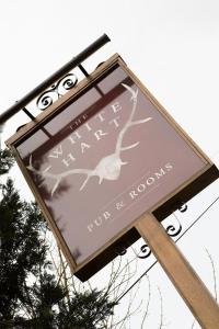 a sign on a pole with a bird on it at The White Hart Ford in Ford