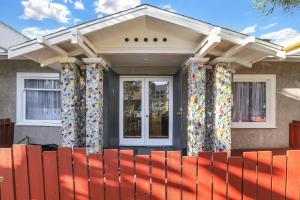 a house with colorful curtains on the front porch at Long Beach House in Long Beach