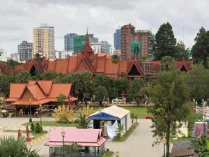 a view of a park with a city in the background at The Bright Lotus Guesthouse in Phnom Penh