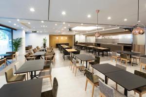 an empty restaurant with tables and chairs at Hotel Bellclassic Tokyo in Tokyo