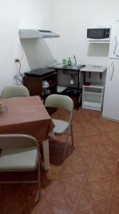 cocina con mesa, sillas y nevera en Apartamento Acoxpa, en Ciudad de México