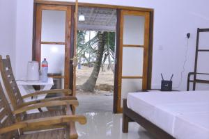 a bedroom with a bed and a table and chairs at Sea View Resort in Galle