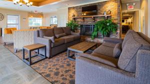 a living room with two couches and a fireplace at Best Western Coach House in Springfield