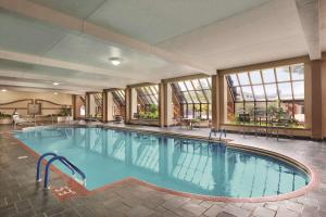 a large swimming pool in a hotel with windows at Hyatt Regency Green Bay in Green Bay