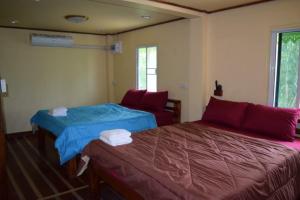 Postel nebo postele na pokoji v ubytování Ruanmai Style Resort 1