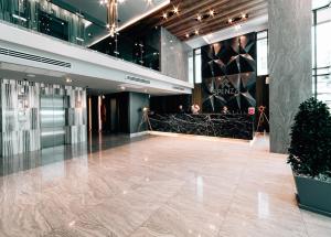 a lobby of a building with a marble floor at Spenza Hotel in Bangkok