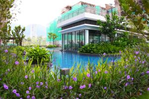 a building with a swimming pool in front of a building at CHARMING & COZY HOME @ MIDHILLS GENTING in Genting Highlands
