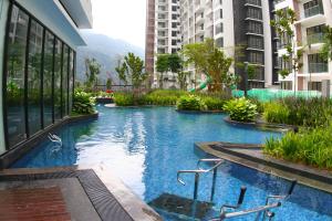 a swimming pool in the middle of a building at CHARMING & COZY HOME @ MIDHILLS GENTING in Genting Highlands
