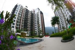 an apartment complex with a swimming pool and some flowers at CHARMING & COZY HOME @ MIDHILLS GENTING in Genting Highlands +17 photos