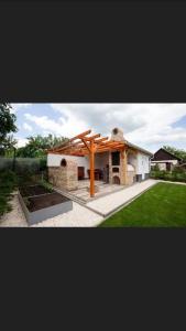 a house with a pavilion in a yard at Juhar Wellness vendégház in Sátoraljaújhely