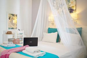 a bedroom with a bed with a mosquito net at Camara Hotel in Agios Prokopios