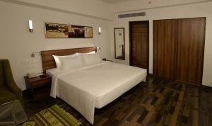 Voodi või voodid majutusasutuse Lemon Tree Hotel Coimbatore toas