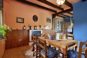 een keuken en eetkamer met een houten tafel en stoelen bij Eguzki B&B in Durango