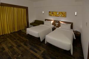 Voodi või voodid majutusasutuse Lemon Tree Hotel Coimbatore toas