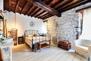 um quarto com uma cama e uma parede de pedra em CR La Posada de los Sentidos em Jarandilla de la Vera