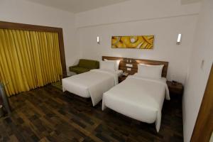 Voodi või voodid majutusasutuse Lemon Tree Hotel Coimbatore toas
