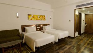 Voodi või voodid majutusasutuse Lemon Tree Hotel Coimbatore toas