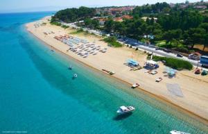 an aerial view of a beach with chairs and umbrellas at Summer Sun in Skala