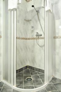 a shower with a glass door in a bathroom at Olevi Residents in Tallinn